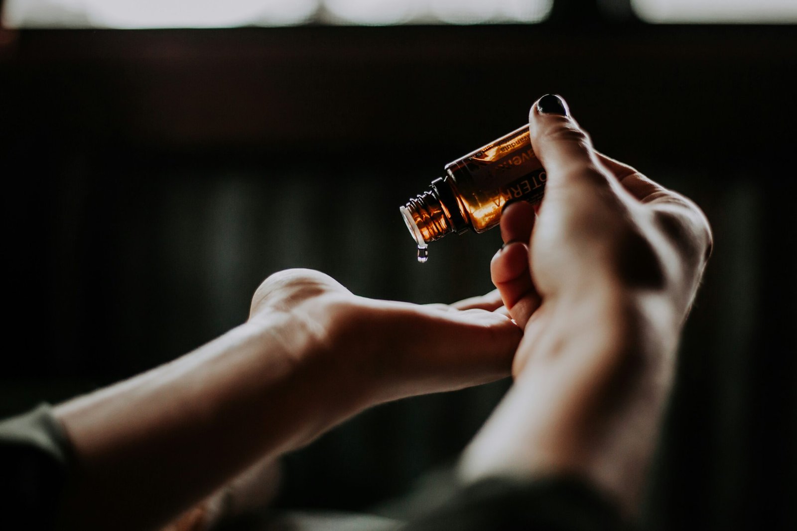 person holding amber glass